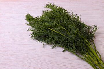 green grocery herbs on white wooden surface with space for text