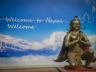 Welcome to Nepall label with a statue of the god Garuda in Kathmandu airport