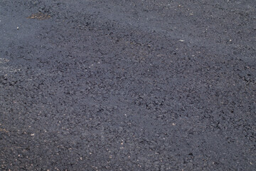 Close up shot at newly layed asplhalt surface in Wroclaw during renovation of Obornicka street.