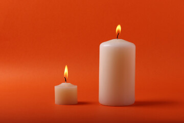 aroma vanilla candels on the orange mono color background. minimalism