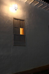 Rustic window with a dim light in the middle of the night