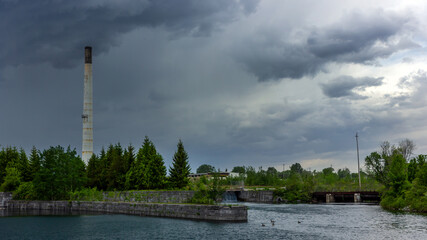 Fototapeta na wymiar scenic rainy industrial landscape panorama of abandoned factory in Canada just before thunderstorm