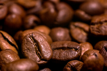 A handful of coffee beans in close-up. Coffee background.