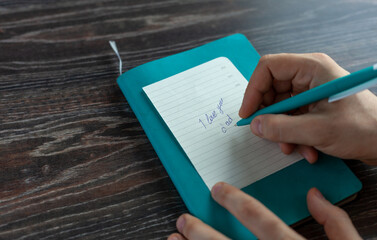 close-up pen in hand a note for dad i love you dad, wood background