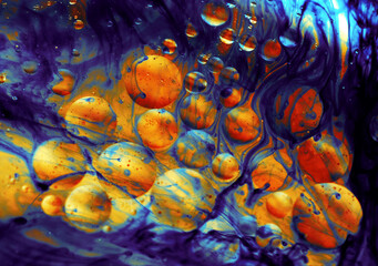 Water and oil bubbles with blue, red and yellow background