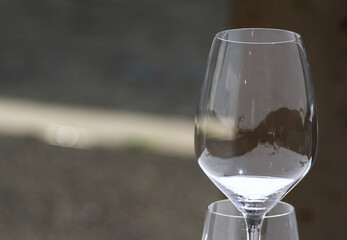 Transparent glasses on the table of an outdoor restaurant, white tablecloth, daylight.