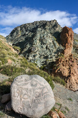 Carved colurful rocks on trekking kora around mountain Kailash Day 1 pilgrimage route near Darchen, Tibet, Asia