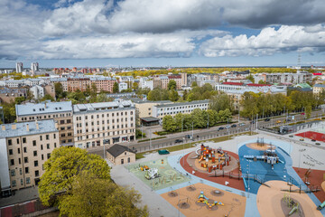 Suburbs in Riga with colorful playground, cobble streets, infrastructure and shiny rooftops. ...
