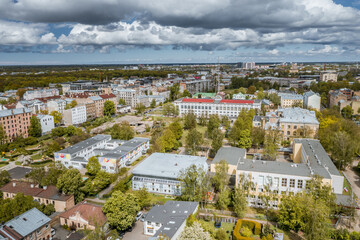 Suburbs in Riga with colorful playground, cobble streets, infrastructure and shiny rooftops.  Football arena, basketball courts. 