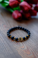 Cool design black bracelet with hamsa hand symbol.