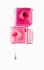 Close up of pink fingernail polish dripping from bottles