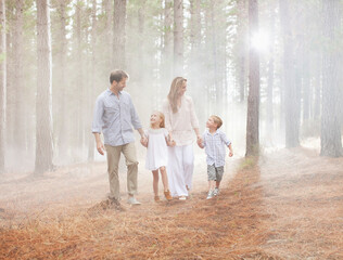 Happy family walking in sunny woods