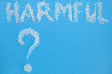 Harmful, inscription on sugar, an question mark. Diet and weight loss, refusal of sweet. Diabetes problems, harm from eating, dependence on flavoring. Pain in the teeth, caries. Blue background.