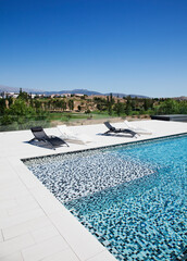 Lounge chairs and swimming pool