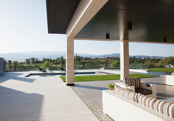 Fototapeta na wymiar Luxury patio overlooking swimming pool and mountains