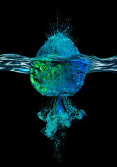 Blue and green balloon hitting water