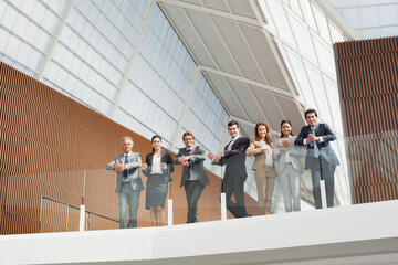 Portrait of smiling business people leaning on balcony railing