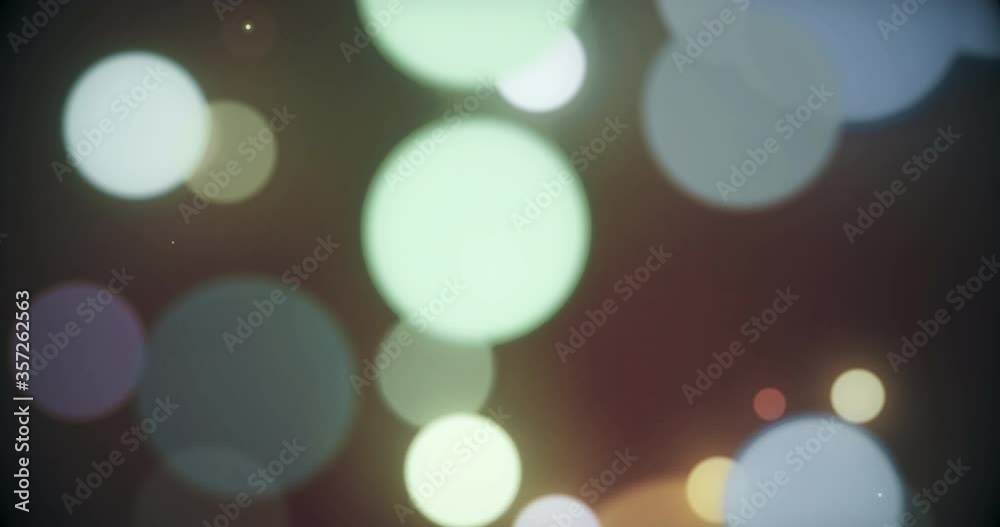 Wall mural colorful defocused particles bokeh with a blurred depth of field. multi-colored bokeh moving floatin
