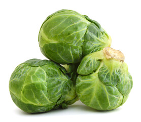 freshly brussel sprouts and some whole ones on a white background