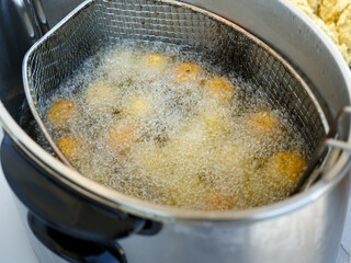 delicious fried round homemade falafel in boiling oil