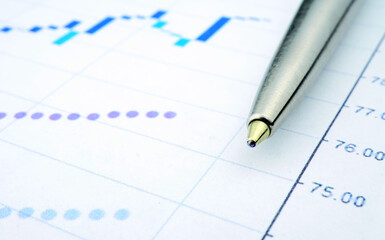 Trading chart and pen on a sheet of paper. Stock quotes in the form of a graph. Business project on paper. Profitable shares. Profit from financial activities. Risky business.