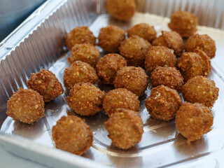 delicious fried round homemade falafel in boiling oil