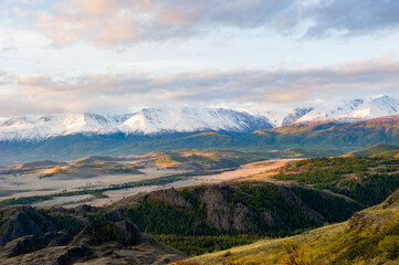 beautiful sunrise, an amazing view of the Altai mountains covered with snow, the autumn steppe, the Chuya river.