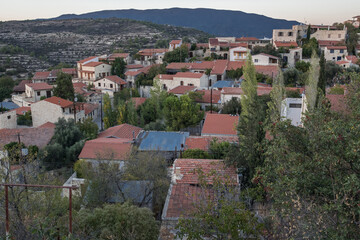 Fototapeta na wymiar View of red tiles roofs in Lofou, a small, picturesque and hilly village in Lymassol district, Cyprus. 