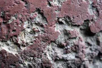potholes in an old concrete painted wall.