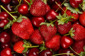 Macro of tasty ripe strawberries and juicy cherries.Berries background.