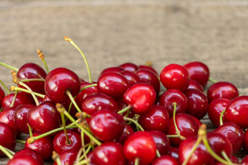 Tasty cherries on wooden background, the benefits of cherries