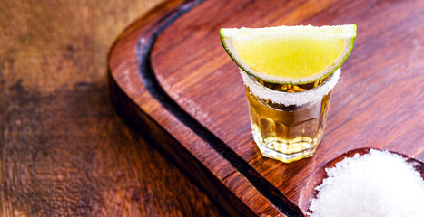 Mexican drink with lemon and salt, called tequila. Space for text.
