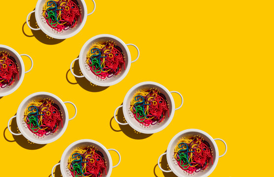 Pattern of colanders with colorful pasta