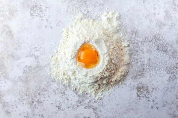 Close-up of egg yolk in flour