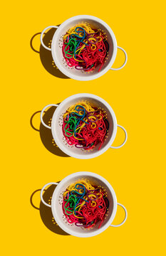 Studio shot of colanders with colorful pasta