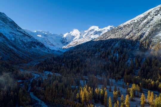 Switzerland, Canton of Grisons, Saint Moritz, Drone view of forested valley of?Morteratsch Glacier in autumn