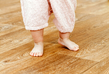 baby feet on linoleum, first step, close-up