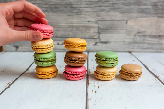 Hand of person picking up macaroon biscuit