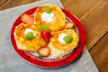 cheesecakes with raspberry and sour cream on a plate