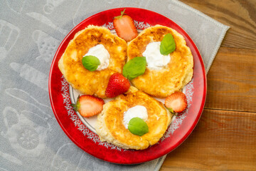 cheesecakes with raspberry and sour cream on a plate