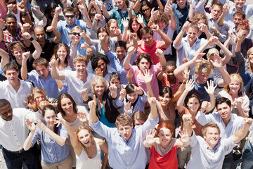 Portrait of crowd cheering with arms raised - Powered by Adobe