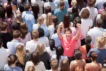 Portrait of enthusiastic man cheering in crowd