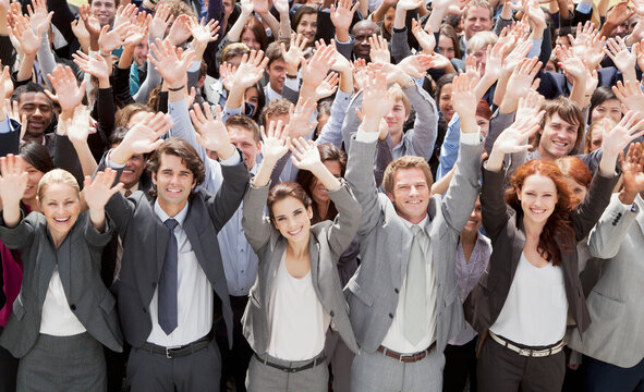 Portrait Of Cheering Business People In Crowd