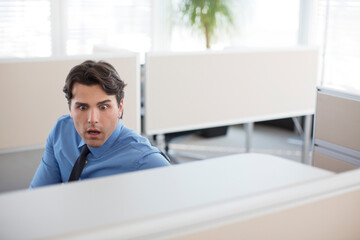 Fototapeta premium Surprised businessman working in office