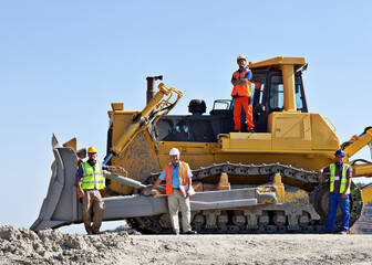 Workers on bulldozer smiling in quarry © Martin Barraud/KOTO