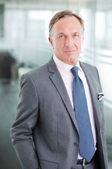 Businessman standing in office hallway