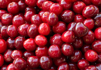 Red and tasty cherry texture, background. The benefits of cherries