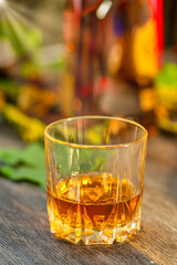 Glass of whiskey on a wooden table