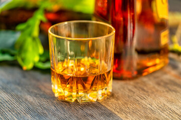Glass of whiskey on a wooden table