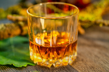 Glass of whiskey on a wooden table